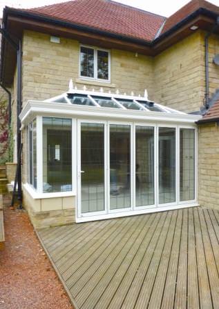 Ultraframe conservatory featuring bi-fold doors and structural eaves beam